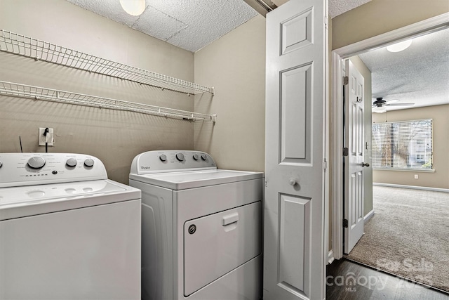 clothes washing area featuring washer and dryer, a ceiling fan, a textured ceiling, and laundry area