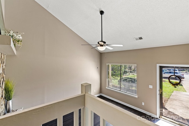 room details with ceiling fan, baseboards, visible vents, and a textured ceiling