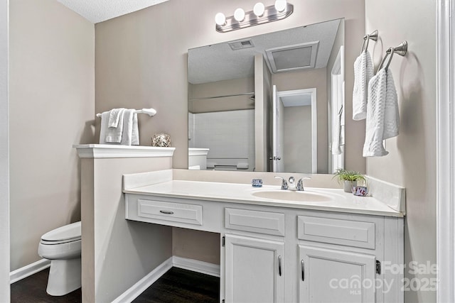 full bathroom with vanity, wood finished floors, baseboards, visible vents, and toilet