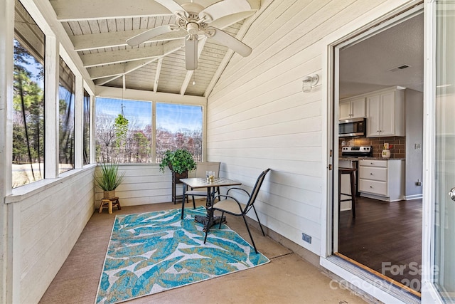 sunroom with visible vents, wooden ceiling, lofted ceiling with beams, and a ceiling fan