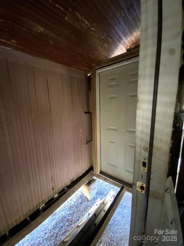 interior space with wood walls and wooden ceiling