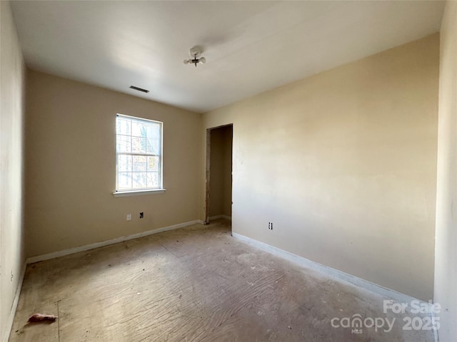 unfurnished room featuring visible vents