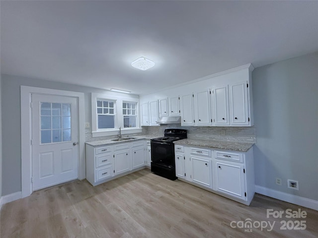 kitchen featuring under cabinet range hood, white cabinets, black electric range oven, and a sink