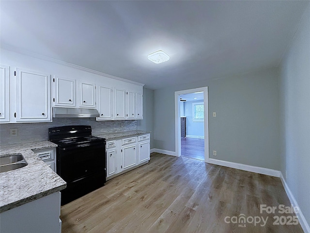 kitchen featuring under cabinet range hood, tasteful backsplash, white cabinets, and black electric range oven