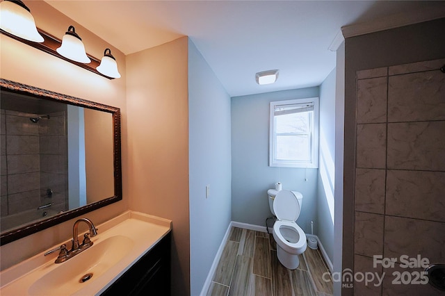 full bathroom featuring vanity, baseboards, wood tiled floor, a shower, and toilet