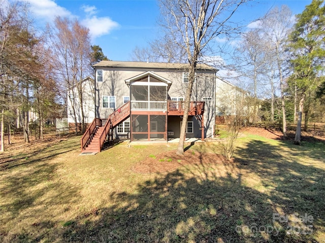 back of property featuring stairway, a wooden deck, a yard, and a sunroom