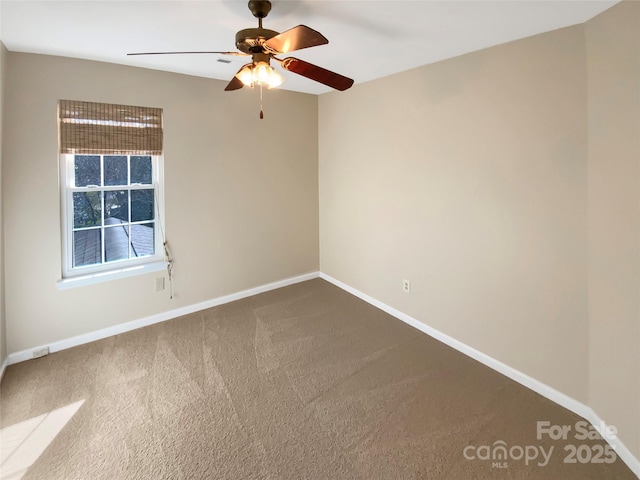 empty room featuring baseboards, carpet floors, and ceiling fan