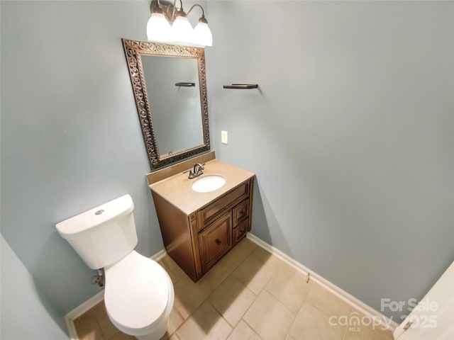 bathroom featuring vanity, baseboards, tile patterned floors, toilet, and a chandelier