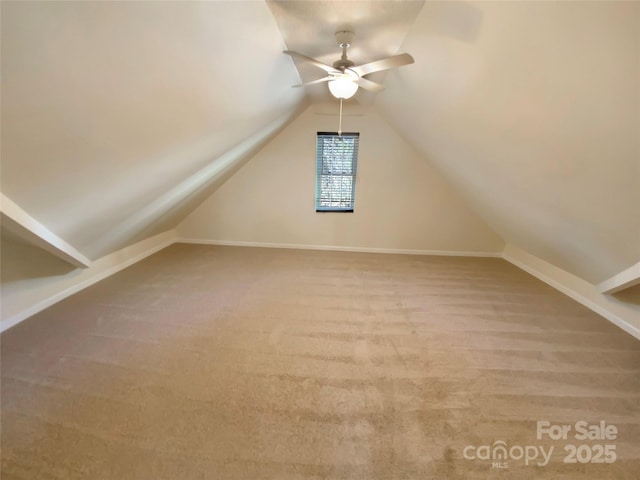 additional living space featuring carpet flooring, baseboards, ceiling fan, and vaulted ceiling