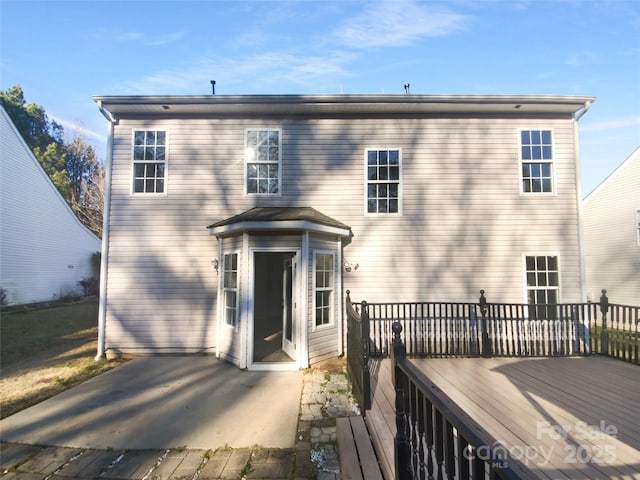 rear view of house with a wooden deck