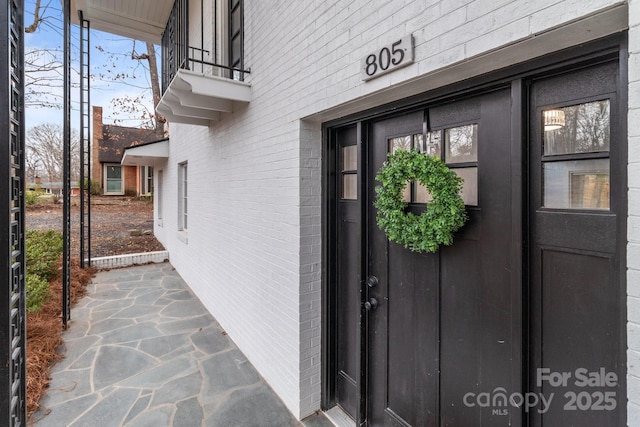 property entrance with brick siding