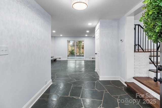 hall featuring visible vents, baseboards, stairway, recessed lighting, and stone tile flooring