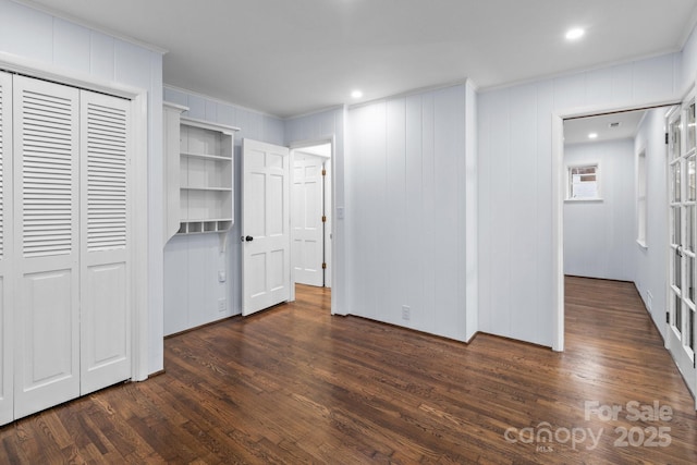 unfurnished bedroom with dark wood finished floors, recessed lighting, a closet, and ornamental molding