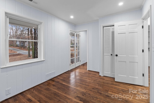 interior space with visible vents, recessed lighting, crown molding, and dark wood-type flooring