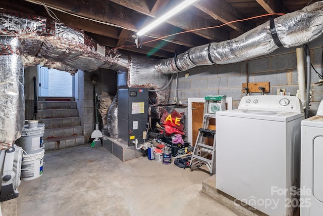 below grade area featuring washing machine and clothes dryer and stairs