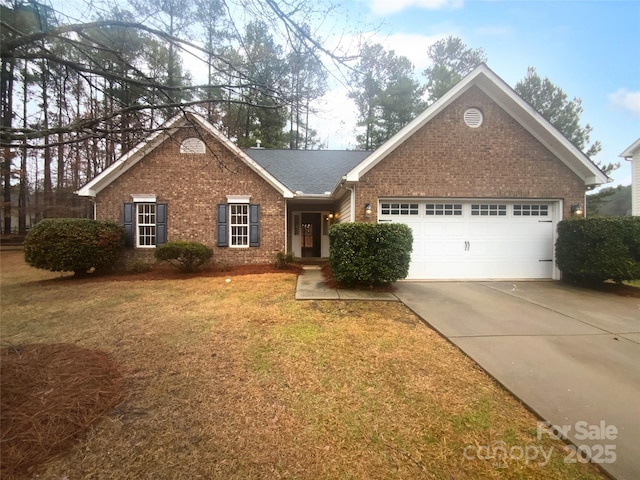 view of front of property with a front yard, driveway, roof with shingles, an attached garage, and brick siding