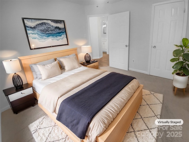 carpeted bedroom featuring baseboards