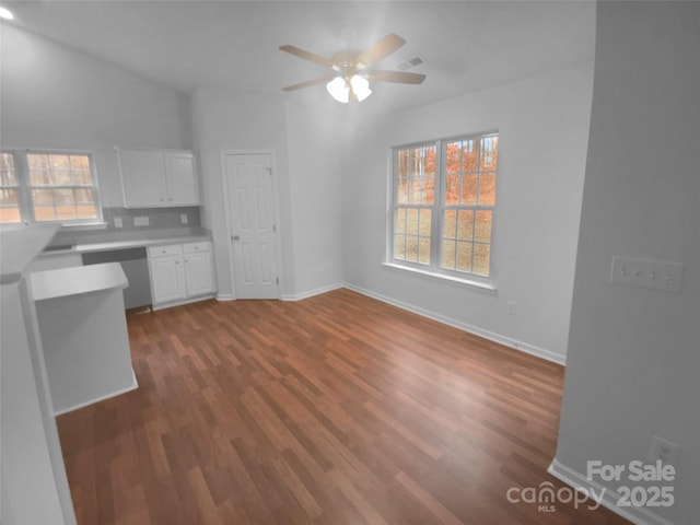 interior space featuring wood finished floors, white cabinets, light countertops, dishwasher, and built in study area