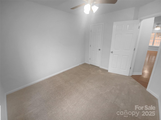 unfurnished bedroom with a ceiling fan, carpet, and baseboards