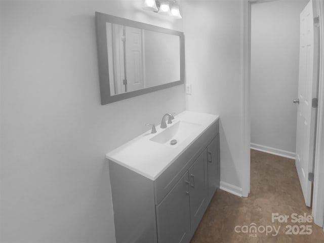 bathroom with baseboards and vanity