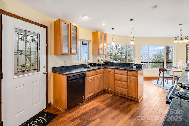 830 Fortescue Rd, Zirconia, NC 28790 - kitchen with a sink, black appliances, glass insert cabinets, dark wood finished floors, and a peninsula