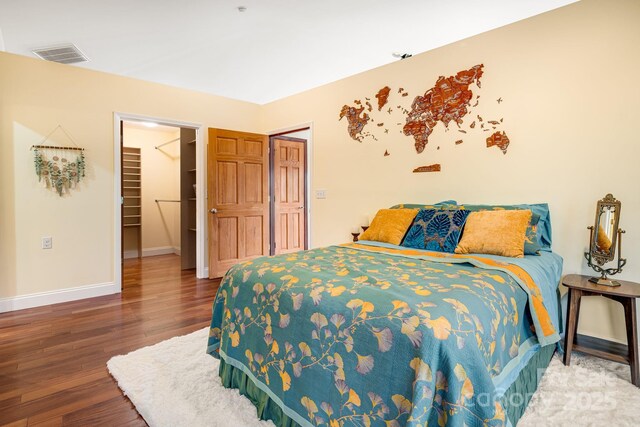 830 Fortescue Rd, Zirconia, NC 28790 - bedroom featuring wood finished floors, a closet, a walk in closet, baseboards, and visible vents