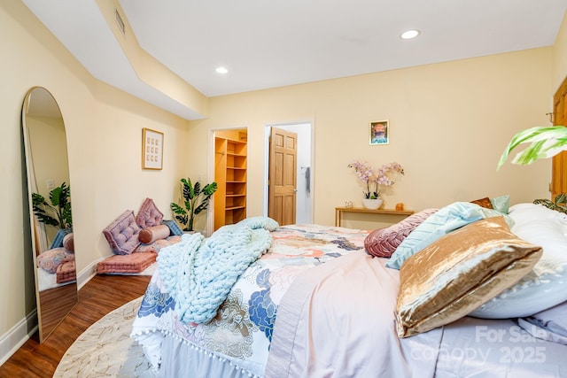 830 Fortescue Rd, Zirconia, NC 28790 - bedroom featuring baseboards, recessed lighting, dark wood-type flooring, and a walk in closet