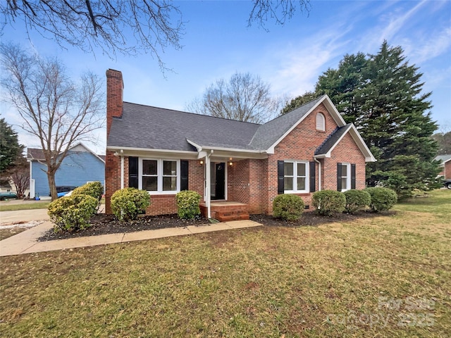 ranch-style home featuring brick siding, a chimney, a front lawn, and a shingled roof