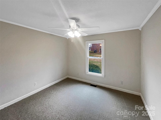 unfurnished room with ceiling fan, baseboards, crown molding, and carpet