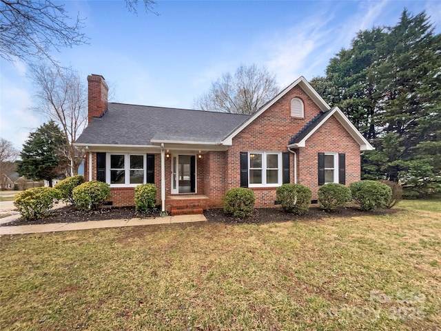 view of front facade featuring crawl space, brick siding, a chimney, and a front yard