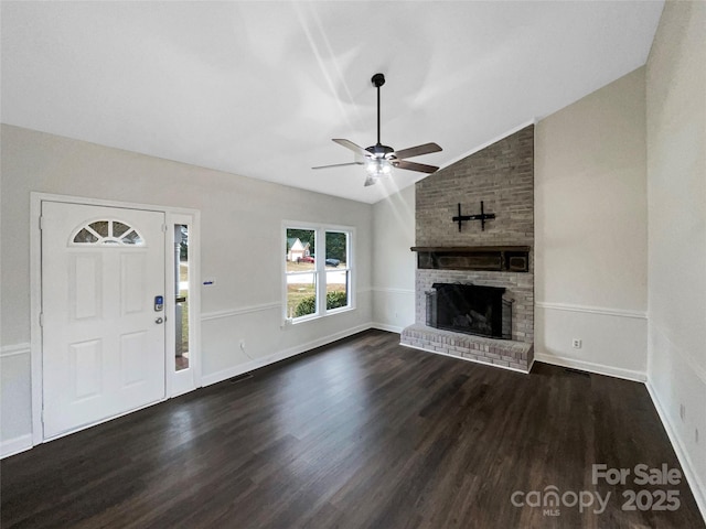 unfurnished living room with a fireplace, dark wood-type flooring, ceiling fan, and vaulted ceiling