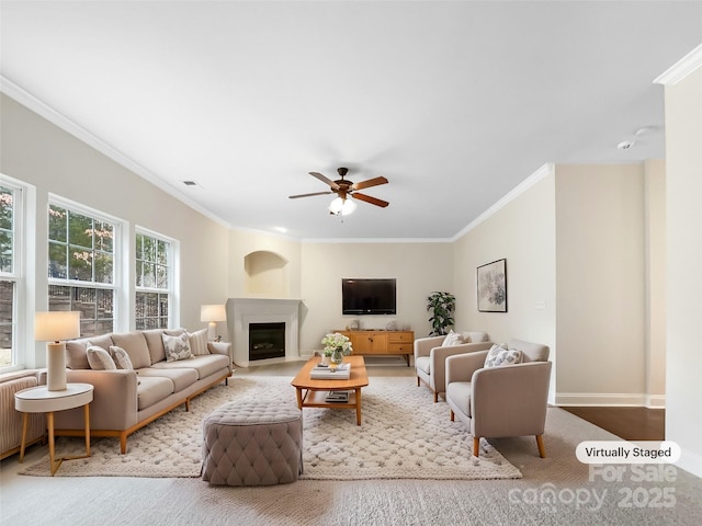 living area featuring visible vents, ceiling fan, radiator heating unit, ornamental molding, and a fireplace