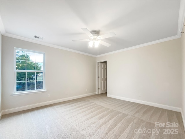 spare room with baseboards, light carpet, and ornamental molding