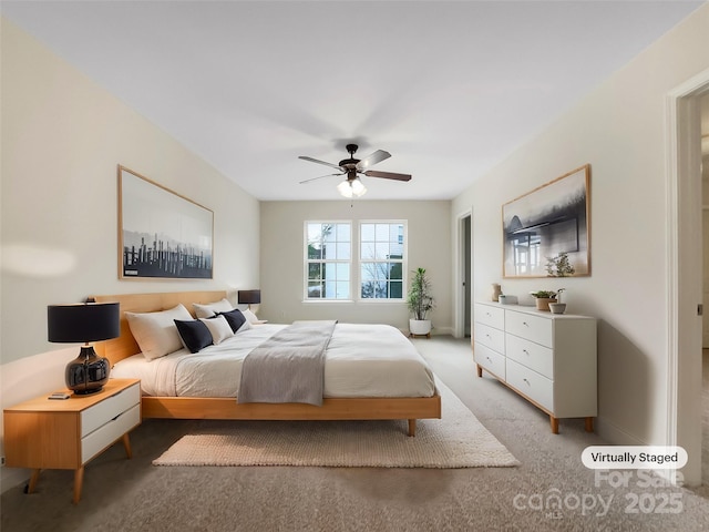 bedroom featuring a ceiling fan and light colored carpet