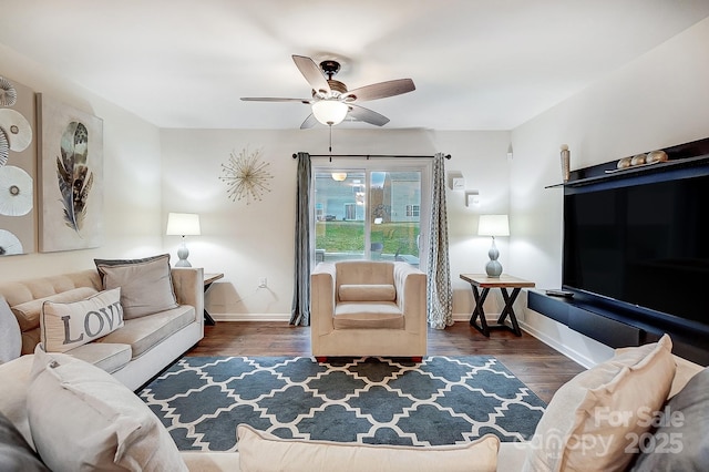 living area with a ceiling fan, wood finished floors, and baseboards