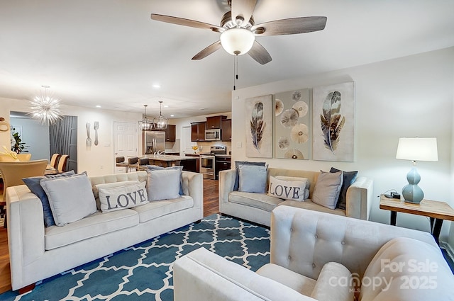 living room with recessed lighting, wood finished floors, and a ceiling fan