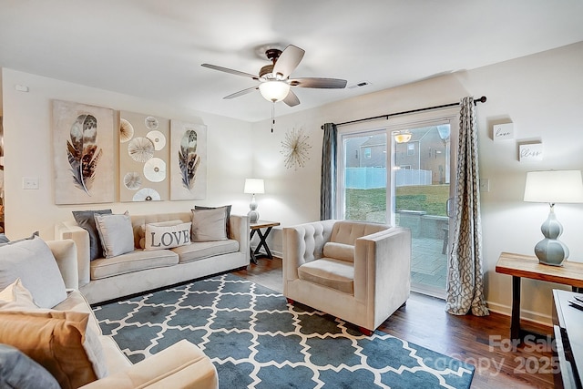 living room with baseboards, wood finished floors, visible vents, and ceiling fan