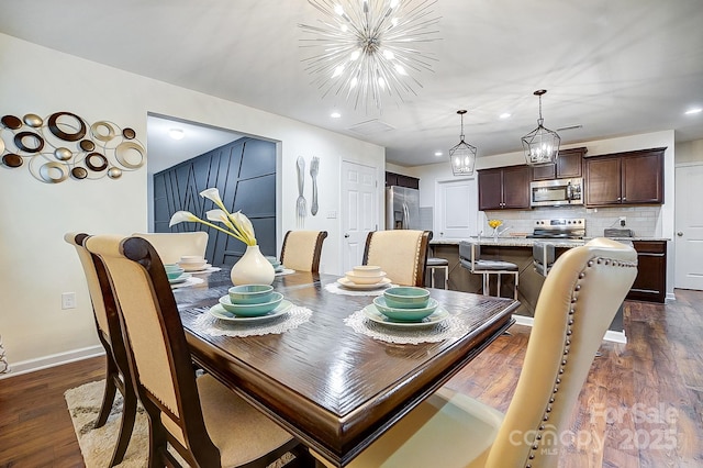 dining space with recessed lighting, a notable chandelier, and dark wood-style floors