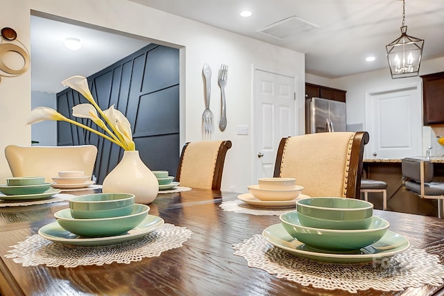 interior details with recessed lighting, visible vents, freestanding refrigerator, and a chandelier