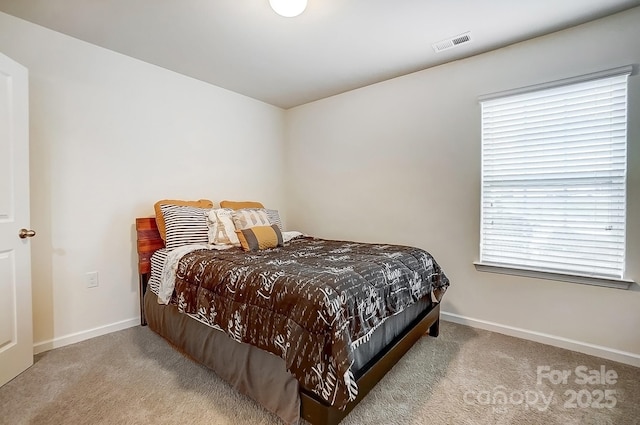 carpeted bedroom with baseboards and visible vents