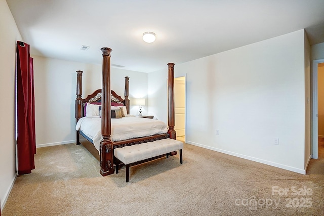 carpeted bedroom featuring visible vents, baseboards, and ornate columns