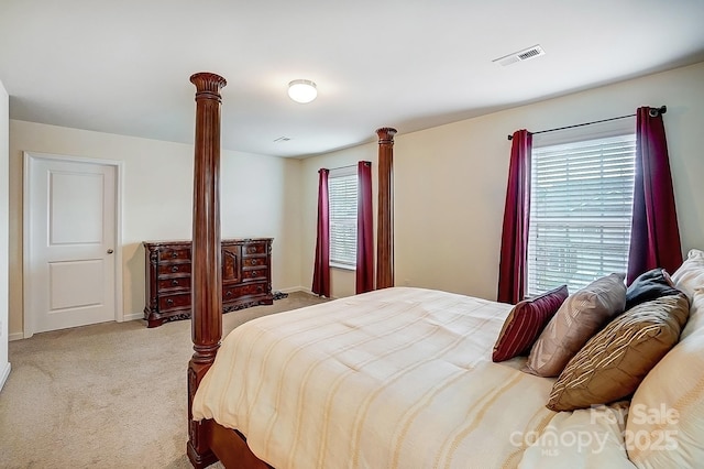 bedroom with carpet, visible vents, and baseboards