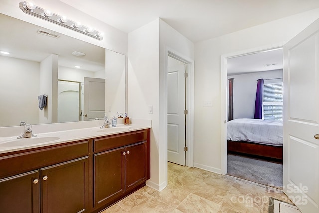 full bath with double vanity, visible vents, ensuite bathroom, and a sink