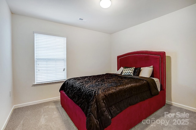 carpeted bedroom featuring visible vents and baseboards