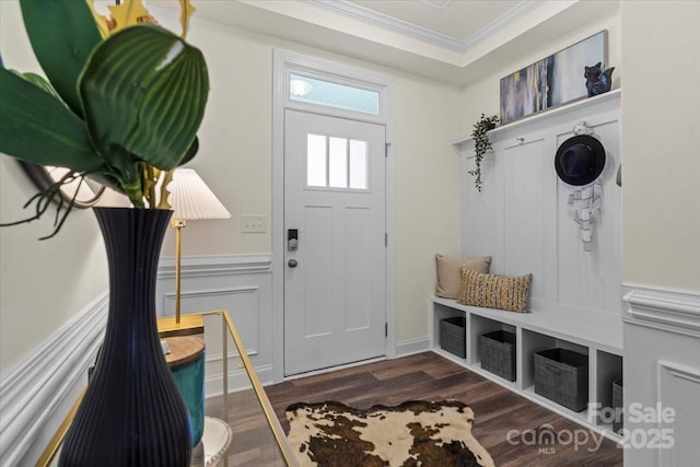 mudroom featuring wainscoting, dark wood-style flooring, crown molding, and a decorative wall