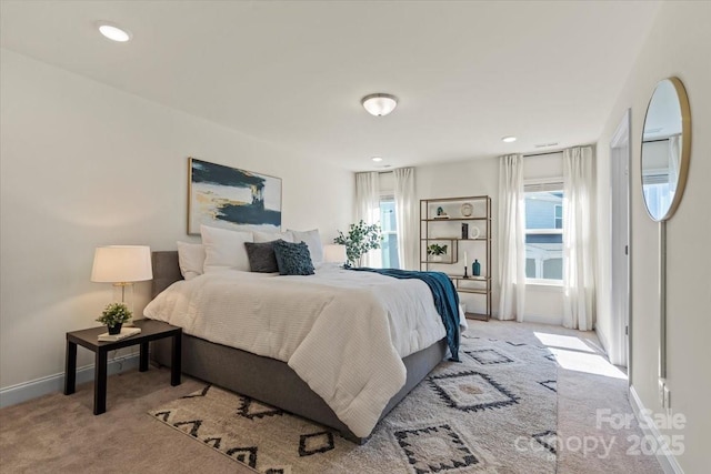 carpeted bedroom featuring recessed lighting, multiple windows, and baseboards