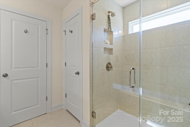 full bath featuring a shower stall and tile patterned flooring