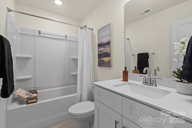 bathroom featuring vanity, toilet, shower / bathtub combination with curtain, and visible vents