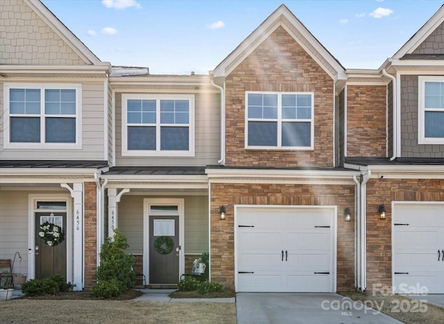 multi unit property with a garage and concrete driveway