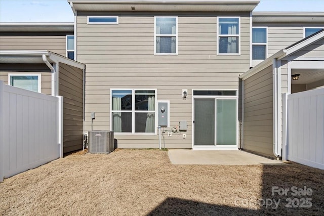 rear view of property featuring central air condition unit, a patio, and fence